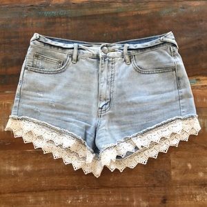 Free People distressed denim shorts with lace trim